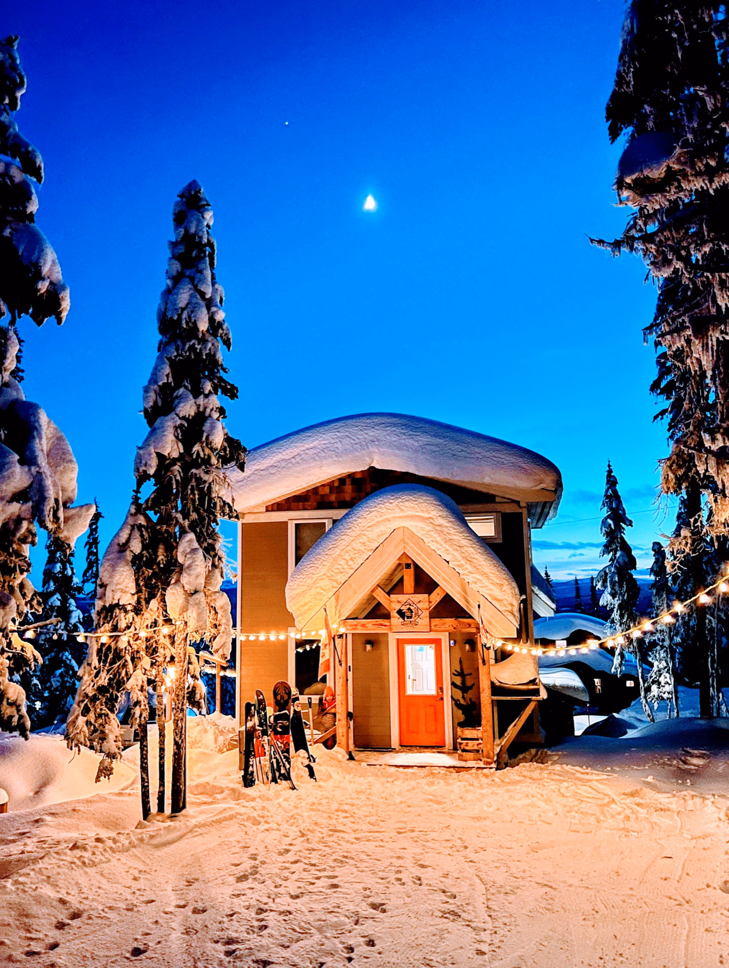 Bonnie Doon cabin lit up under a winter moon