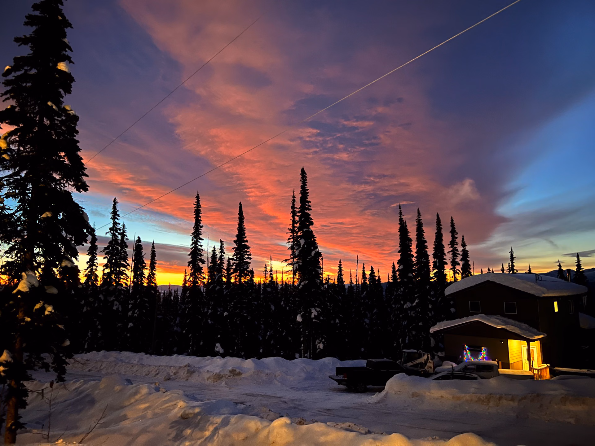 Vibrant pink winter sunset over snowy forest, Smithers BC