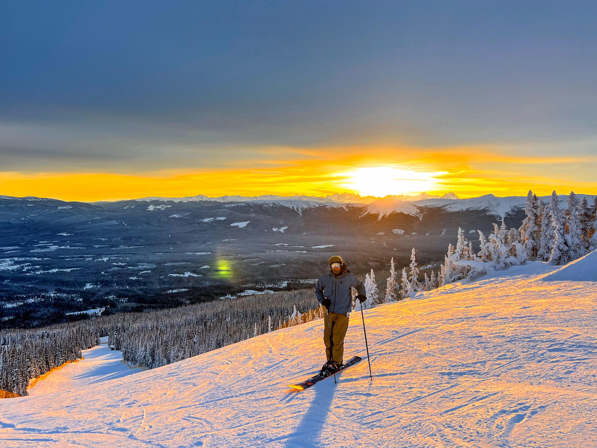 Skier on Hudson Bay Mountain ski run at golden sunrise